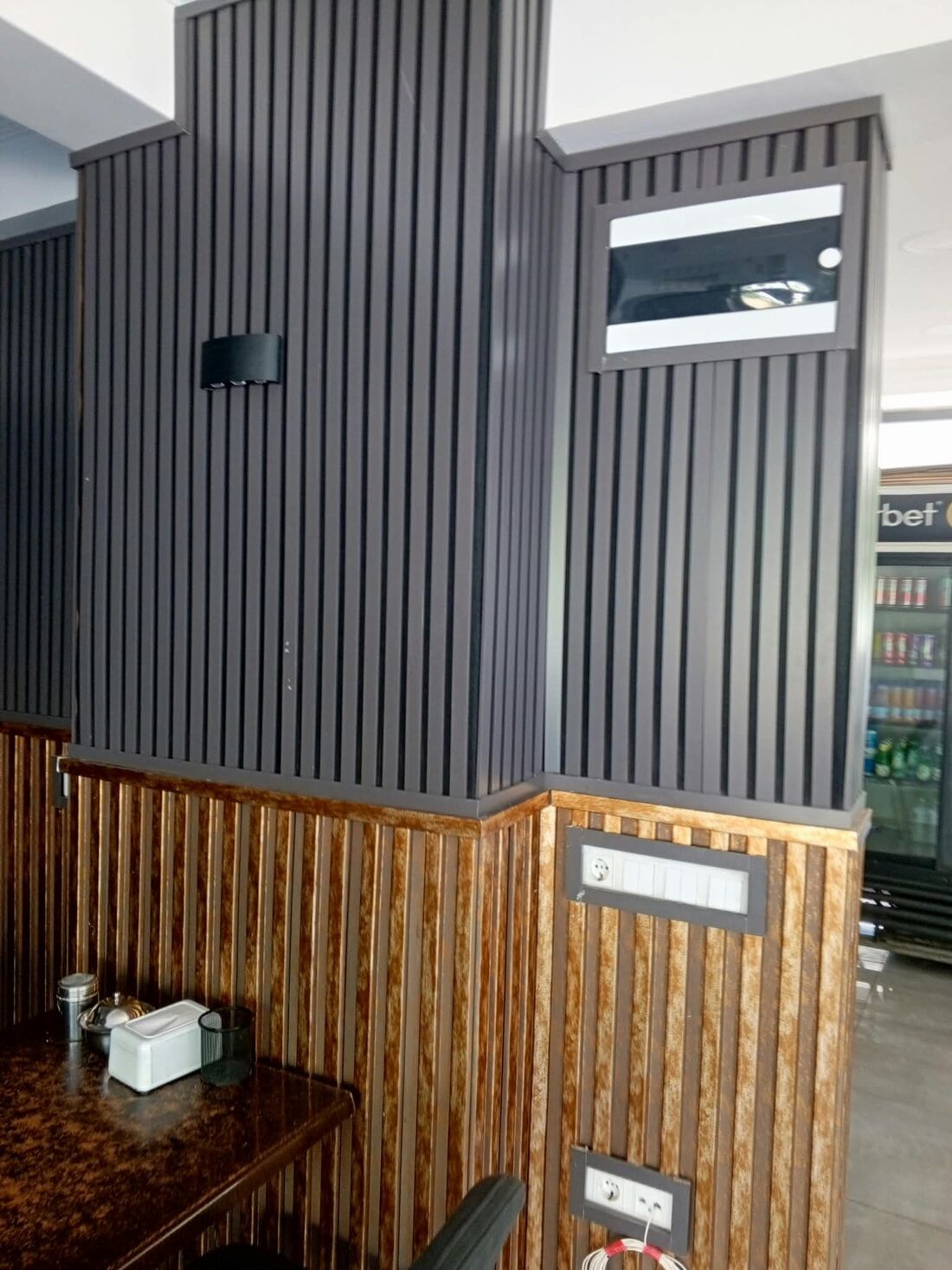 Kolon çevresinde antrasit lata ve ahşap görünümlü panel kaplama